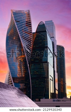 Tops of modern corporate buildings against the gloomy red sunset sky. high-rise buildings and skyscrapers Moscow International Business Center. Royalty-Free Stock Photo #2129920340