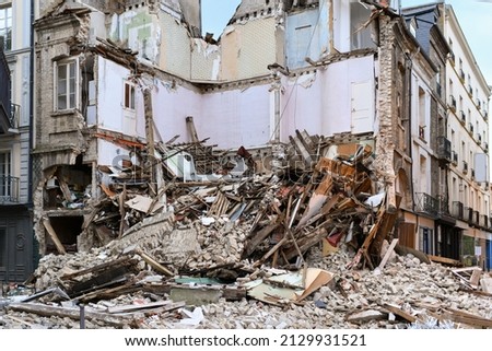 Ruined house after an earthquake Planks bricks Royalty-Free Stock Photo #2129931521