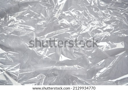Plastic wrap texture for overlay. wrinkled stretched plastic effect. transparent plastic wrap on white background. Food rumpled cellophane wrap