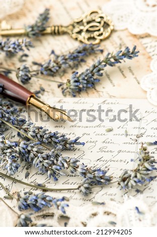 vintage ink pen, key, lavender flowers and old love letters. retro style toned picture