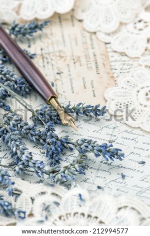 vintage ink pen, dried lavender flowers and old love letters. retro style toned picture. selective focus