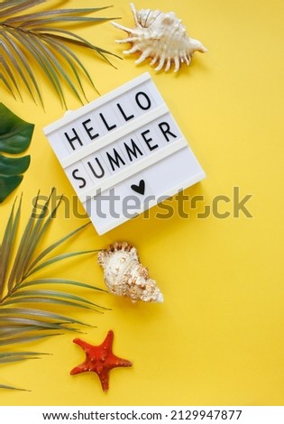 Lightbox with text Hello Summer. Travel accessories items on color background, Summer vacation concept. Top view. Copy space.