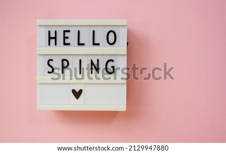 lightbox with text Hello spring on pink background. Top view Flat lay Springtime concept