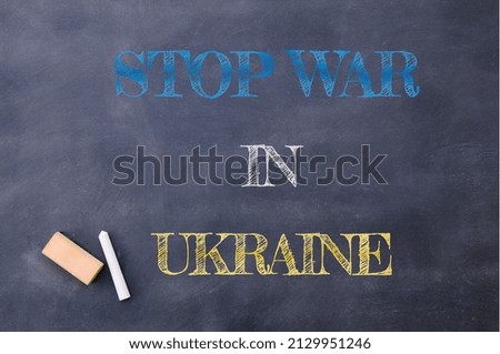Stop war in Ukraine painted with colored chalk on a blackboard.
