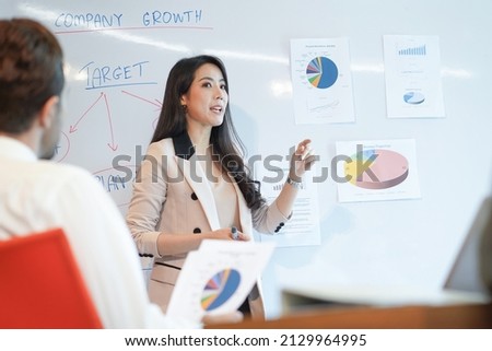 Woman business coach speaker give presentation speaker presenter consulting reporting presenting to CEO or group leader explain graph strategy profit growth result in company meeting 