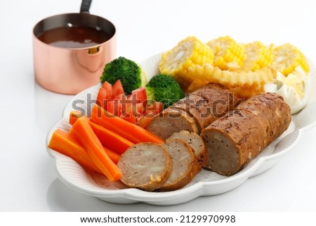 Galantine or Meatloaf is a Rolled Ground Chicken with Flour, Served with Steam Vegetable and Barbeque Sauce 