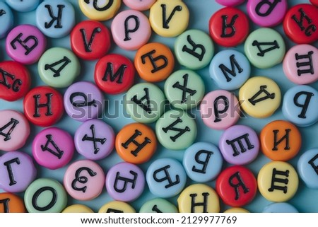 Cyrillic letters colorful buttons on a pastel background. Russia, Eastern Europe conceptual backdrop.