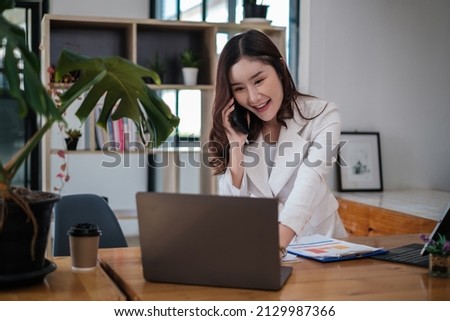 Asian Businesswoman or Accountant hands holding paperwork with calculator, account and saving concept.