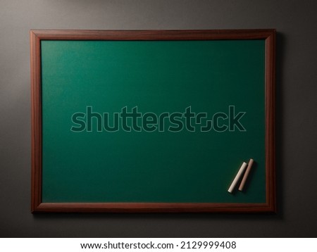 Textured blackboard with chalks, horizontal frame.