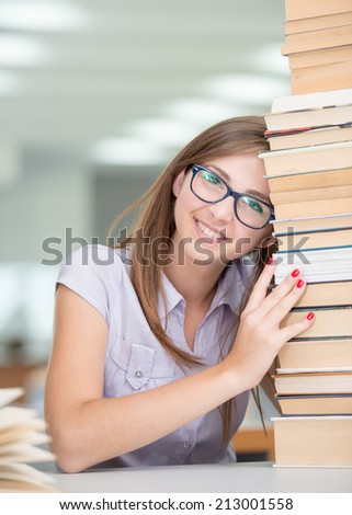 College female student on university campus with pile of books