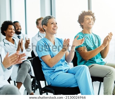 Portrait of a young doctors and nurses in audiance during a seminar in a board room or during an educational class at convention center  Royalty-Free Stock Photo #2130026966