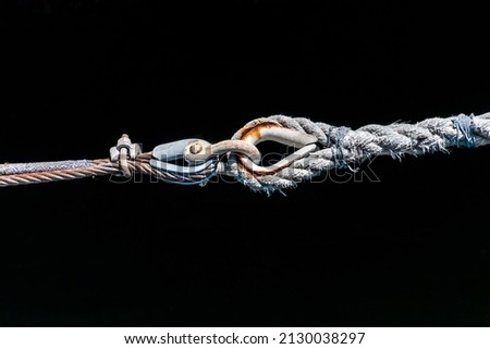 Mooring and docking line connections from cable-to-shackle-to-braided line eye. Royalty-Free Stock Photo #2130038297