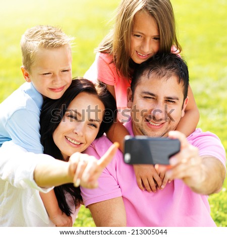 family taking selfie with smartphone