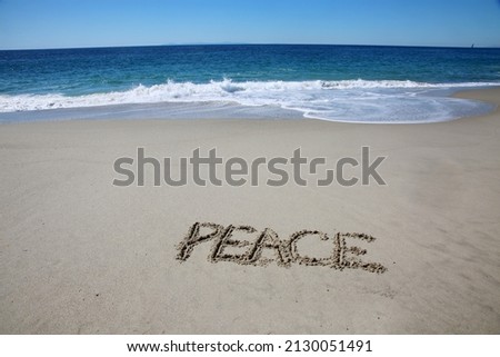 Words Written in the sand. The word PEACE written in the sand with the ocean in the background. Peace around the world. Peace.