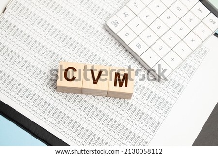 Customer Value Management word composed on the wooden cubes with a calculator