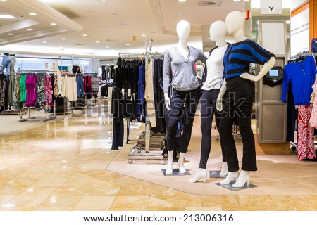 Interior of a fashion and designer clothing store. Royalty-Free Stock Photo #213006316