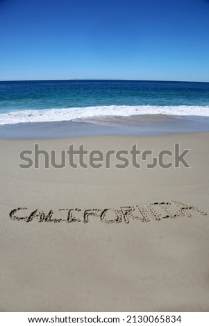 California. California 2022. Words written in the sand with the Ocean Background. The word California written on the beach in Laguna Beach California. Location Shot of a Laguna Beach location. 