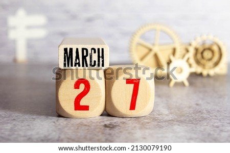 March 27th. Image of march 27 wooden color calendar on white background. Spring day, empty space for text. World Theatre Day