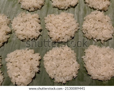 Rengginang, a typical Indonesian cracker, is made from glutinous rice. Photo of rengginang crackers lined up and dried in the sun