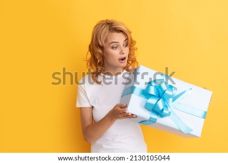 curious redhead girl with present box. happy birthday