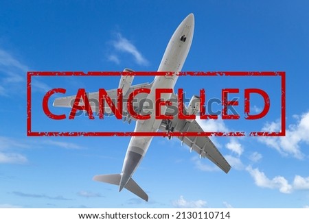 Airplane on blue sky with sign cancelled. Flight cancellations