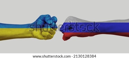 Russian vs Ukrainian flag national painted on fist. Concept of politics, economy conflicts.