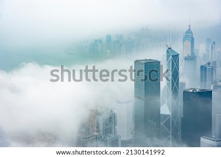 Skyscraper in downtown of Hong Kong city in fog Royalty-Free Stock Photo #2130141992