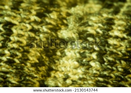 Yellow and gray blurry knitted pattern. Textile macro closeup, natural threads, geometric texture. No selective focus, defocused background.