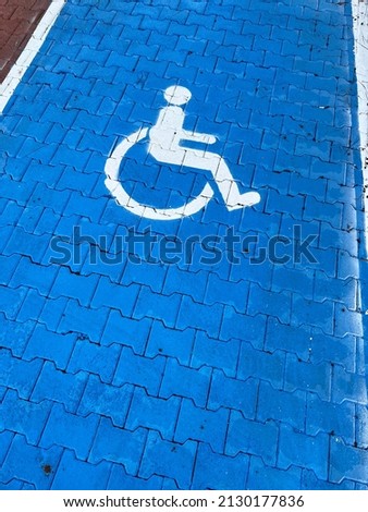 Accessible parking symbol in a car park area