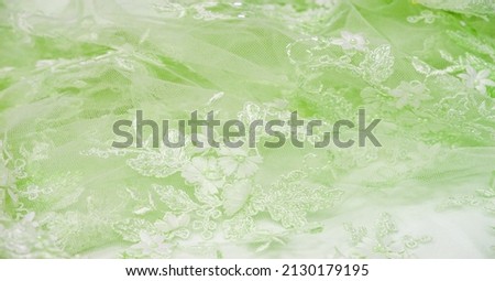 The lace is soft green. Texture. background. template. abstract background with pale green rod, old lace and salad lines. can be used for postcard, poster, texture or wallpaper Royalty-Free Stock Photo #2130179195