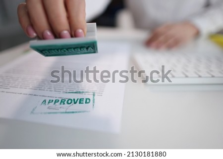 Green approved stamp on document, certificate contract, agreement, lawyer hand Royalty-Free Stock Photo #2130181880