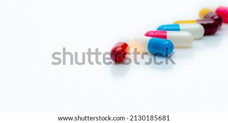 Selective focus on antibiotic capsule pills on white background. Pharmacy horizontal web banner. Prescription drugs. Antibiotic drug resistance. Capsule pill industry. Antibiotic drug selection.  Royalty-Free Stock Photo #2130185681