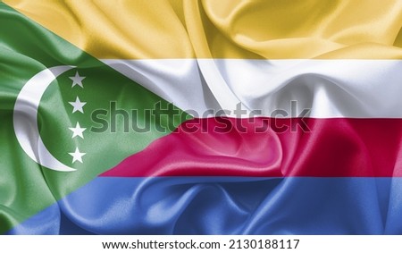 Country Comoros Celebrating Independence Day. Abstract waving flag on gray background