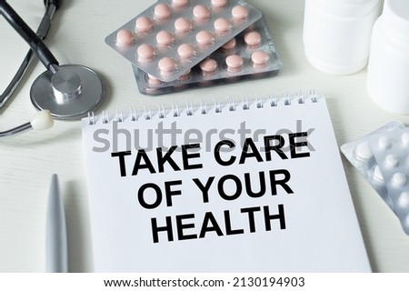 medical concept. Take care of your health inscription on a notepad on a medical table
