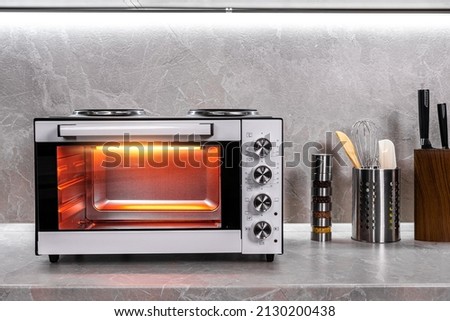 Electric mini oven for homemade cooking Royalty-Free Stock Photo #2130200438