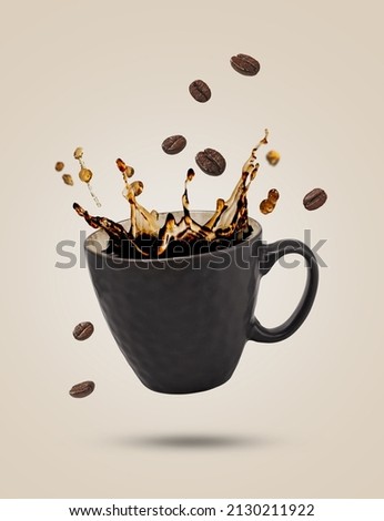 Falling cup of coffee with splash