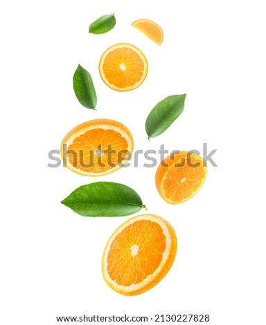 Falling juicy oranges with green leaves isolated on transparent background. Flying defocusing slices of oranges. Applicable for fruit juice advertising Royalty-Free Stock Photo #2130227828