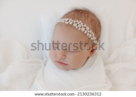 Newborn baby girl - authentic newborn photography session in a white clean studio.