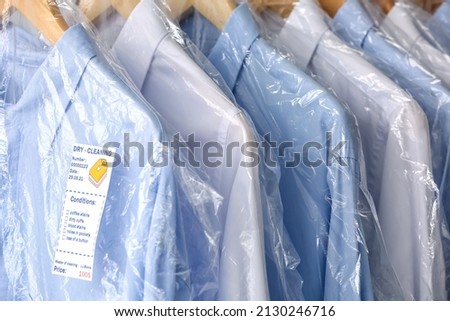 Clean shirts in plastic bags, closeup Royalty-Free Stock Photo #2130246716