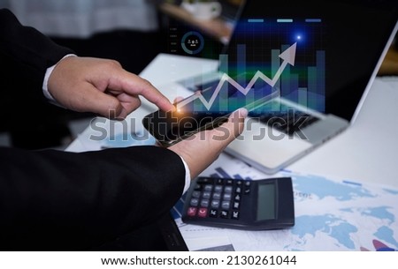 Double exposure of businesswoman hand touch on tablet and laptop with business financial virtual chart, Digital marketing concept. 