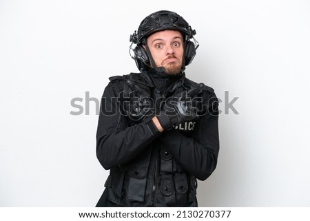 Brazilian soldier man isolated on white background pointing to the laterals having doubts