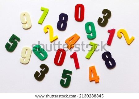 Flat lay of colourful numbers on white background