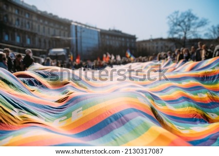 Hundreds of pacifist antiwar people holding peace flag participated at peace rally asking for stopping war Royalty-Free Stock Photo #2130317087