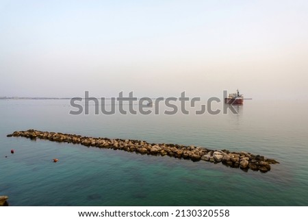 Taranto, Apulia, Italy: a boat near the harbor at evening
