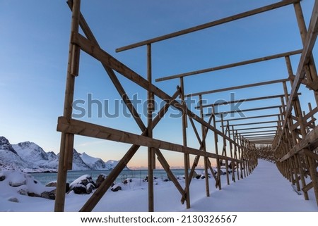 empty drying racks for stockfish near the fishing village Husoy on island Senja in northern Norway