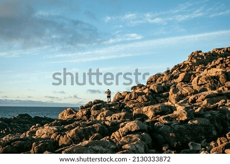 A closeup of a tourist on a rocky mountain