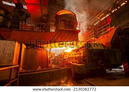 Steelmaker at ingot casting. steelworker at work pouring metal in the workshop, Steelmaking workshop
