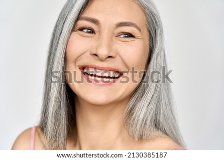 Middle aged happy mature asian woman, senior 50 year lady looking away, isolated on white closeup headshot. Ads of antiaging uv protection whitening menopause dry skincare, plastic surgery. Royalty-Free Stock Photo #2130385187