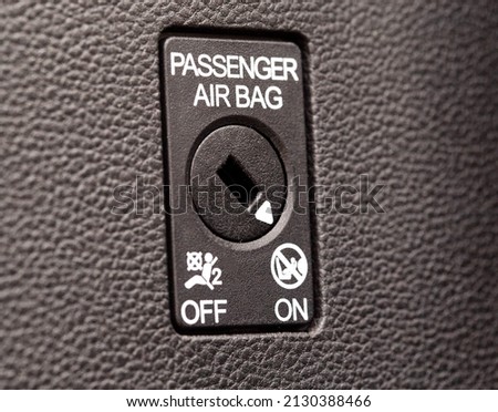 The switch on the panel of the car turns on and off the passenger airbag Royalty-Free Stock Photo #2130388466