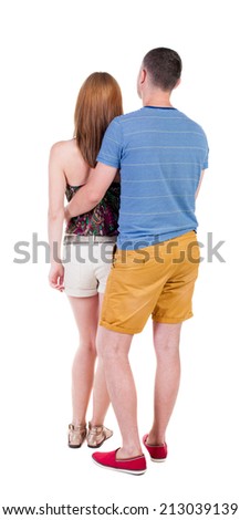 Back view of young embracing couple  hug and look into the distance. beautiful friendly girl and guy together. Rear view people collection.  backside view of person.  Isolated over white background.